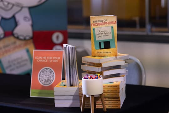 Signing table setup at the Brisbane Convention Centre with copies of The End of Technophobia.