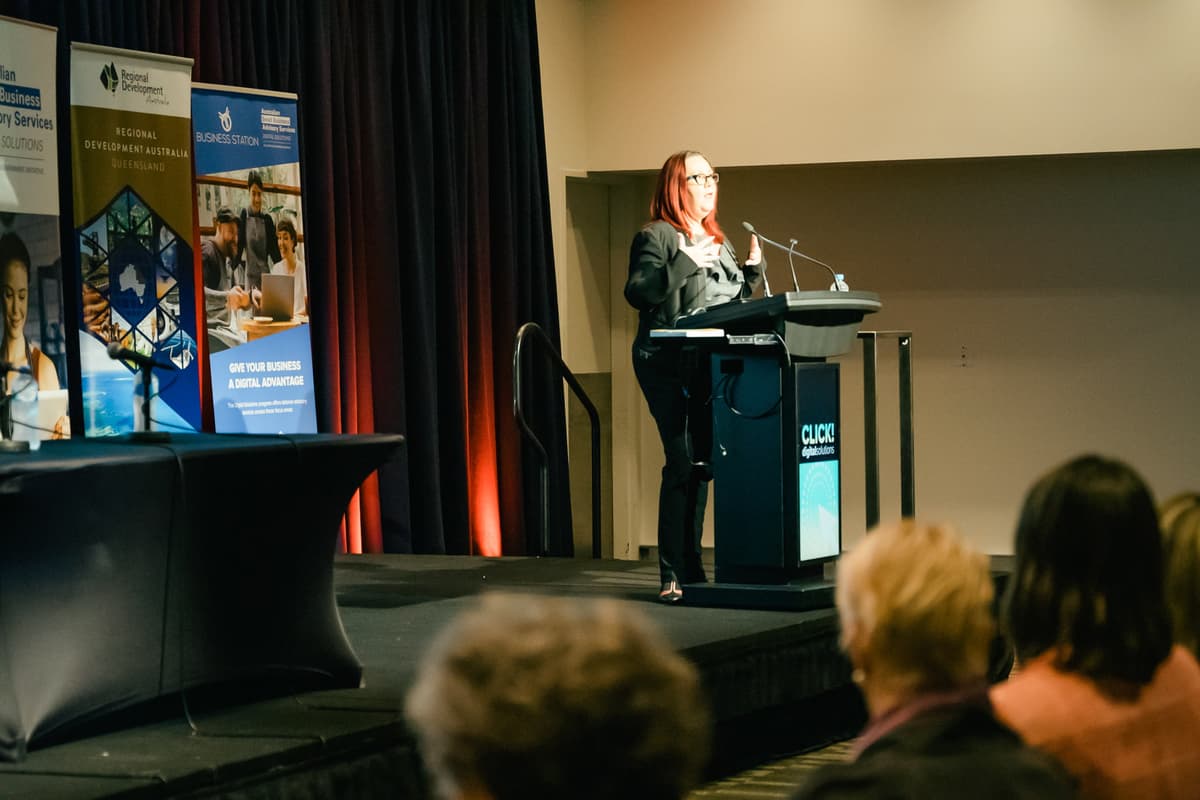 Tracy Sheen at the podium mid-keynote at the Brisbane Convention Centre.