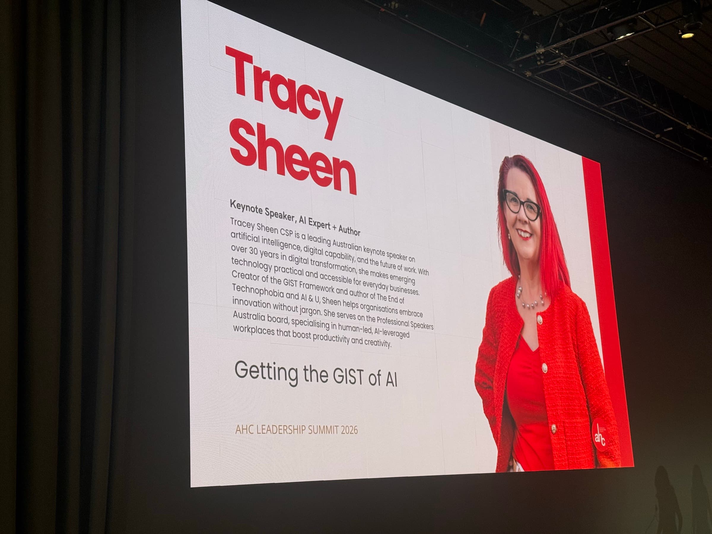 Conference screen at the AHC Leadership Summit showing the keynote title slide, Getting the GIST of AI, with Tracy Sheen as speaker