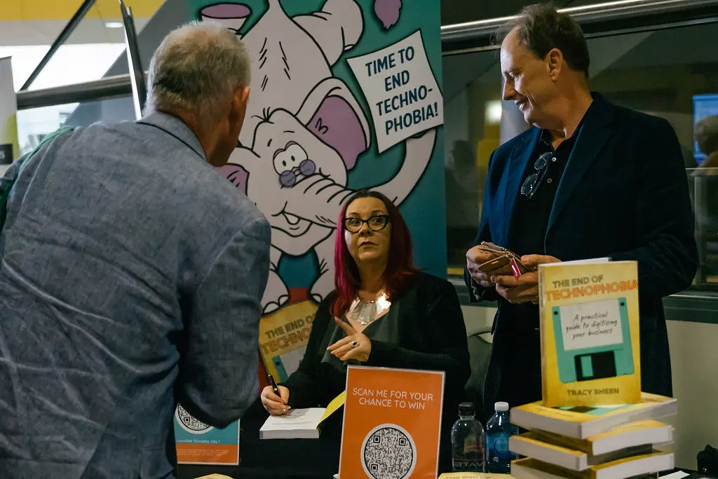 Tracy Sheen signing books at a portable table during a regional roadshow
