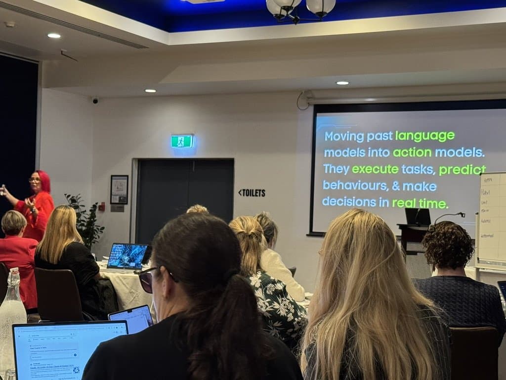Greater Springfield Chamber members watching the Practical AI workshop, a slide about moving past language models into action models on screen