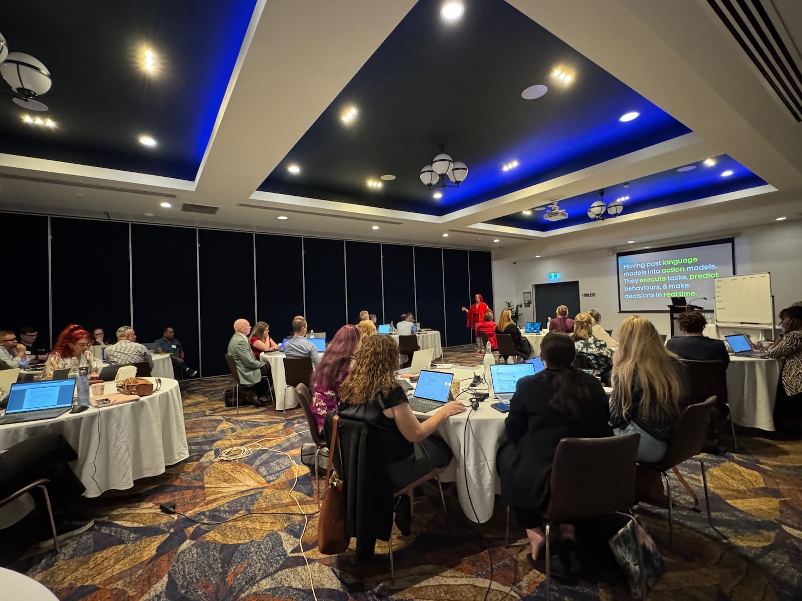 Small business owners working through AI prompts at a Tracy Sheen workshop.